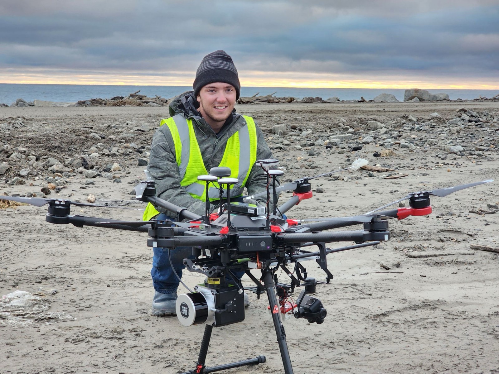 Gerald Fuller with a DJI M600 drone on a beach near Nome