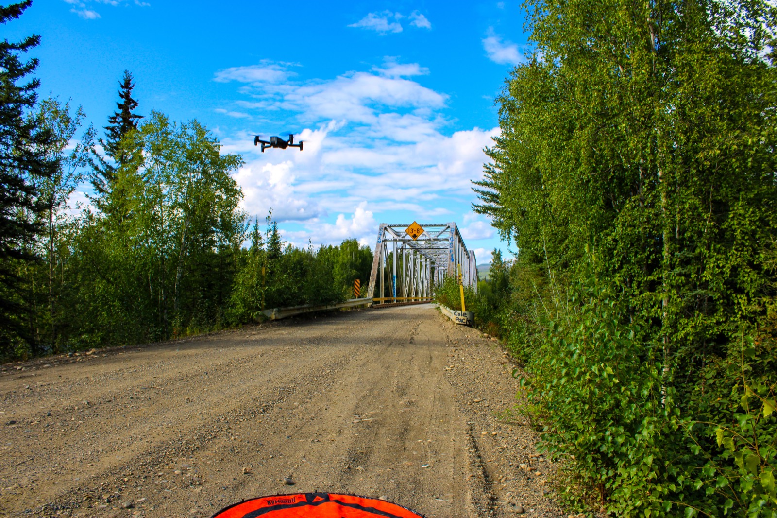 Parrot ANAFI USA taking off over a dirt road toward a bridge