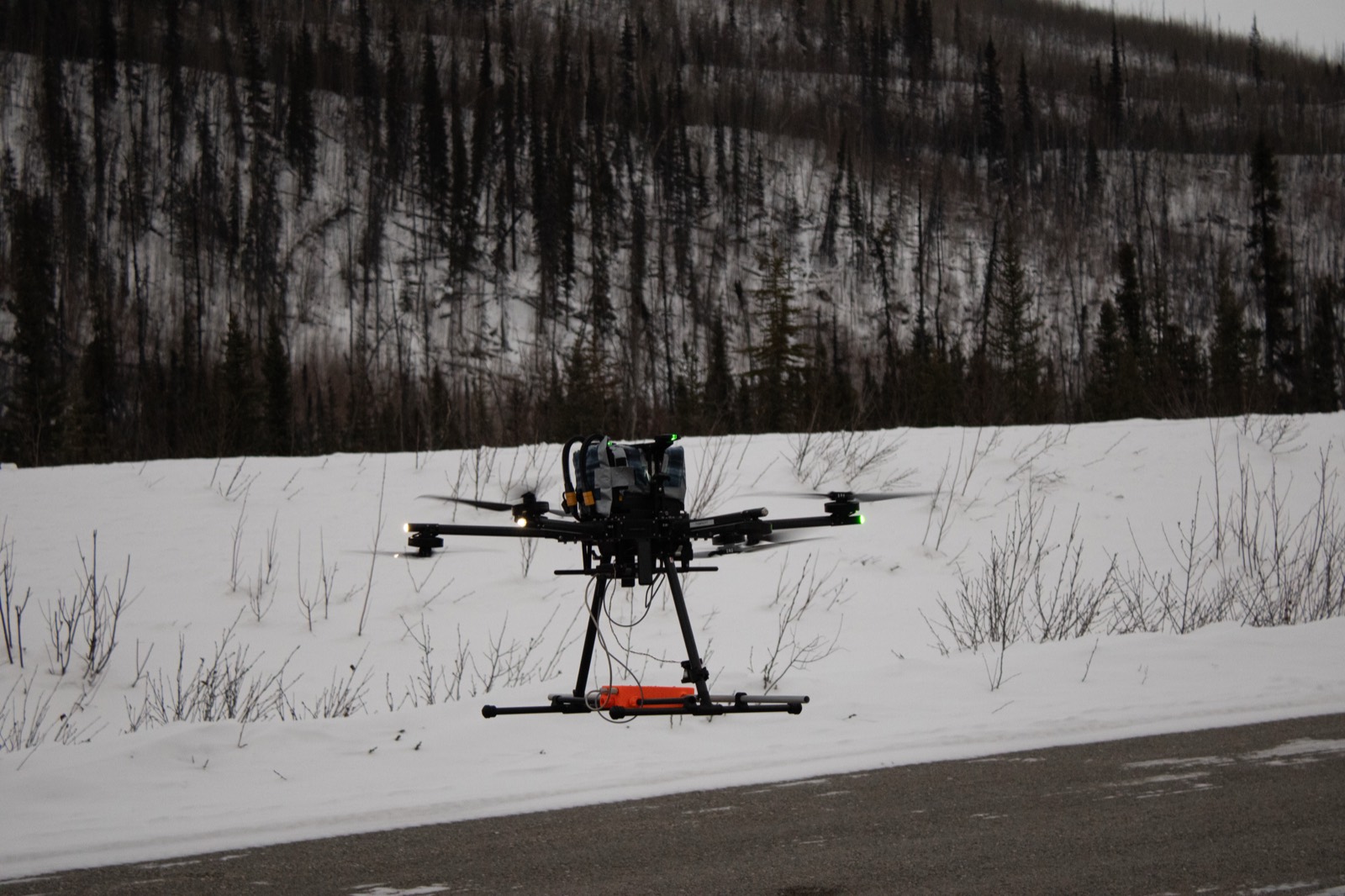 IF1200A drone hovering over a snowy road with a GPR payload